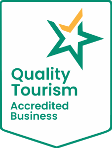 Badge with a green star and text: Quality Tourism Accredited Business.